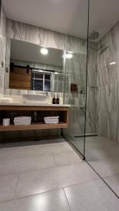 a bathroom with a shower and a large mirror at Fairway Boutique Hotel - Kampala, Uganda in Kampala