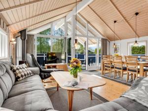 a living room with a couch and a table at Holiday Home Alger - 800m from the sea by Interhome in Marielyst +21 photos