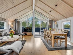 a dining room and living room with a table and chairs at Holiday Home Alger - 800m from the sea by Interhome in Marielyst