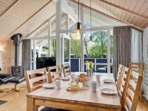 a dining room with a wooden table with chairs at Holiday Home Alger - 800m from the sea by Interhome in Marielyst