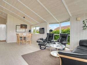 un salon avec un canapé, des chaises et une table dans l'établissement Holiday Home Birtir - 1-2km from the sea by Interhome, à Bøtø By 16 autres photos