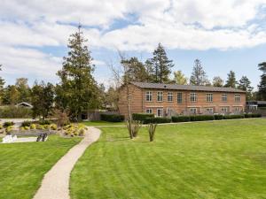 a large brick house with a grassy yard at Apartment Aamunde - 100m from the sea by Interhome in Marielyst
