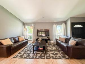 a living room with brown leather couches and a table at Family Vacation Spot - 4BR Home - FB - Cal in Calabasas