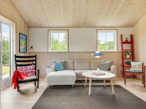 a living room with a couch and two chairs and a table at Holiday Home Finwith - 1-5km from the sea by Interhome in Marielyst