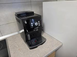 a coffee maker sitting on top of a counter at Milan Luxury Apartaments XVIII in Târgu-Mureş +1 photo