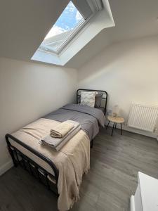a bedroom with a bed and a skylight at ResiLets - Berwick House - Large 4 Bed Townhouse - Contractor stays in Cowpen