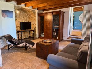 a living room with a couch and a tv at Fermiamoci qui in Bergamo +29 photos