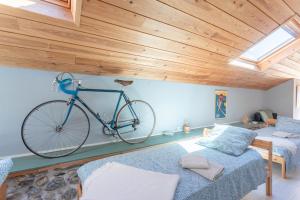 a bike hanging on the wall of a room with two beds at Etape en Barétous - 12 personnes in Aramits