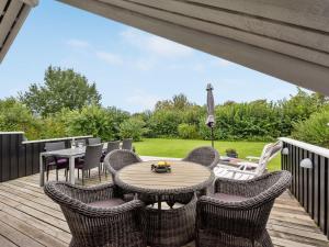 a patio with a table and chairs on a deck at Holiday Home Sella - 500m from the sea by Interhome in Neder Lysabild