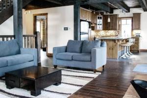 a living room with two blue couches and a coffee table at Chalet Boreal Mont-Blanc in Mont-Blanc