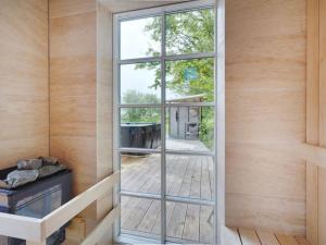 a glass door in a room with a window at Holiday Home Kerkko - 150m from the sea by Interhome in Skovmose