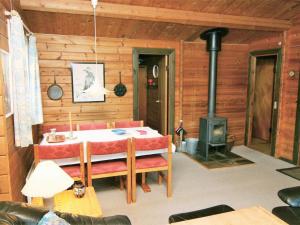 a living room with a table and a stove at Holiday Home Byrge - 2km from the sea by Interhome in Fanø