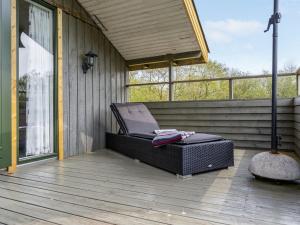 a reclining chair on a screened in porch at Holiday Home Arona - 1-5km from the sea by Interhome in Fanø