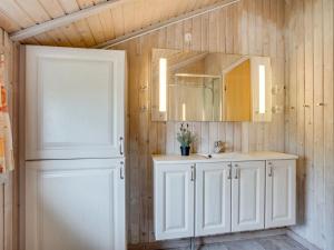 a bathroom with a sink and a mirror at Holiday Home Arona - 1-5km from the sea by Interhome in Fanø