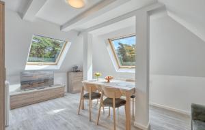 a dining room with a table and a tv at 3 Bedroom Beautiful Apartment In Altenkirchen in Altenkirchen