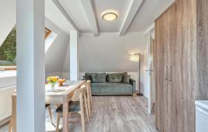 a living room with a table and a couch at 3 Bedroom Beautiful Apartment In Altenkirchen in Altenkirchen