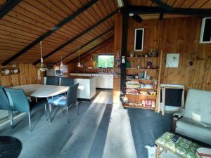 a kitchen and living room with a table and chairs at Holiday Home Rieke - 300m from the sea by Interhome in Skovmose +8 photos