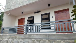 a house with three doors and a balcony at Uno's Krib - Pilar in Pilar