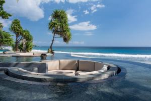 a couch in the water next to the beach at Katamaran Hotel & Resort in Senggigi 
