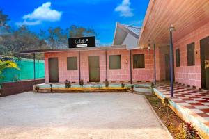 a pink brick building with a sign on it at Collection O Malavli Lonavala Hill View in Lonavala