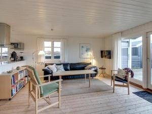 a living room with a couch and a table at Holiday Home Eikka - 600m from the sea by Interhome in Fanø