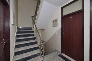 a staircase in a building with a red door at Townhouse Sector 33 Gurgaon in Gurgaon +33 photos