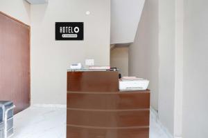 a office with a desk and a sign on the wall at Townhouse Sector 33 Gurgaon in Gurgaon