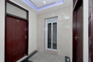 an empty hallway with two doors and a mirror at Townhouse Sector 33 Gurgaon in Gurgaon