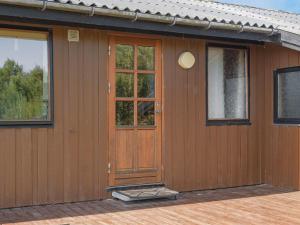 a brown house with a wooden door and windows at Holiday Home Frigga - 400m from the sea by Interhome in Fanø