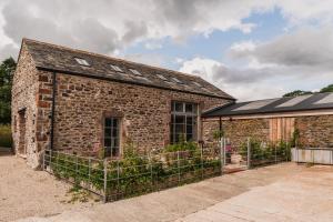an old brick building with plants on it at Swallow Barn at Greenclose Farm in Penrith