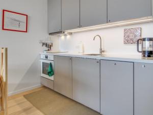 a kitchen with white cabinets and a sink at Apartment Anedorte - 50m from the sea by Interhome in Fanø
