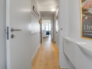 a hallway with white walls and a hallway with two sinks at Apartment Anedorte - 50m from the sea by Interhome in Fanø