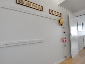 a room with white walls and a shelf on the wall at Apartment Anedorte - 50m from the sea by Interhome in Fanø