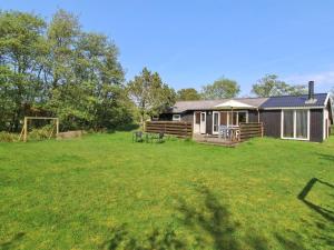 a house with a large yard in front of it at Holiday Home Nielsine - 1-5km from the sea by Interhome in Fanø