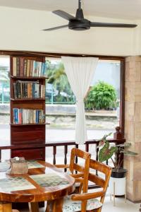 a dining room with a table and a book shelf at Khon Kaen Orchid Hotel in Khon Kaen