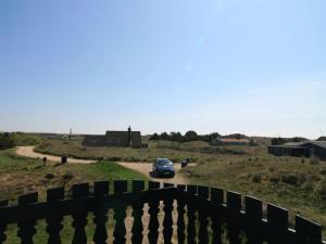 a car driving down a road in a field at Holiday Home Casandra - 600m from the sea by Interhome in Fanø