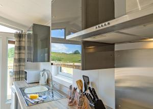 a kitchen with a sink and a window at Cleveland Hills View Holiday Park in Middleton upon Leven