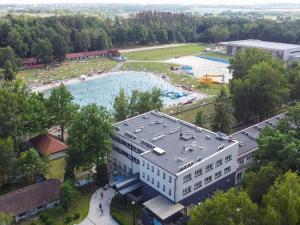 an aerial view of a building with a large swimming pool at Malinowski Leśny in Gliwice