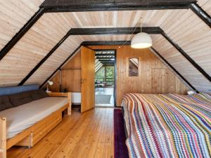 a bedroom in a house with a bed at Holiday Home Jorinde - 2-8km from the sea by Interhome in Toftum