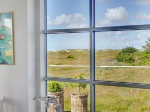 a window view of a field from a house at Holiday Home Ortwin - 300m from the sea by Interhome in Lakolk +43 photos