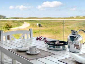 a table with a tea pot and a cup on it at Holiday Home Ortwin - 300m from the sea by Interhome in Lakolk