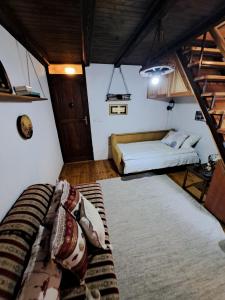 a small room with a bed and a ladder at Sleep, fly, bye bye in Sarajevo