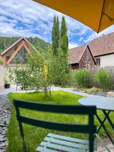 a park bench in front of a house at Gîte avec jacuzzi pour 14 personnes, lacs, vignobles proche Kaysersberg in Lapoutroie +61 photos