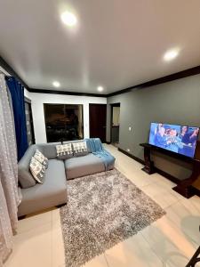 a living room with a couch and a flat screen tv at Fully Equipped 3 beds 2 cars 20-min airport in La Puebla