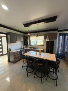 a large kitchen with a table and some chairs at Fully Equipped 3 beds 2 cars 20-min airport in La Puebla