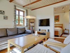 a living room with a couch and a table at Holiday Home Siegried - 2-2km from the sea by Interhome in Vesterhede