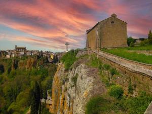 an old church on the side of a cliff at Peter's apartment - Moto & Bike Parking in Castel SantʼElia