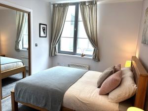 a bedroom with a bed with pillows and a window at 10 Popeshead in York