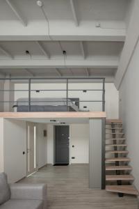 a loft with a bed and stairs in a room at REST INN apart hotel in Cherkasy