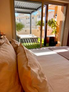 a bed with pillows in a room with a window at French Riviera - Monaco in Beausoleil